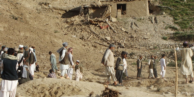 June 11, 2012: Afghans stand at the site after an earthquake hit Baghlan province, north of Kabul, Afghanistan.