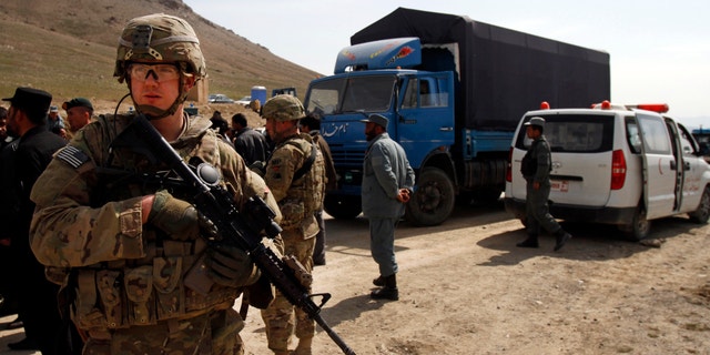 March 11, 2013 - A U.S. soldier secures the scene after U.S. forces shot on an Afghan truck on the road between Kabul and Bagram, Afghanistan, Monday.