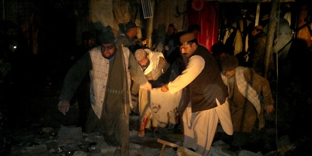 Feb. 25, 2014: Afghans carry the dead body of a civilian after a suicide attack in Trin Kot, capital of Uruzgan province,  Afghanistan.