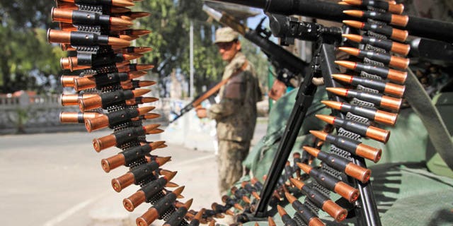Oct. 18, 2011: An Afghan policeman stands guard at a checkpoint in Jalalabad, Afghanistan.