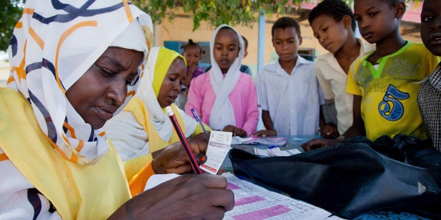 Children register for a meningitis vaccination at the School for Midwives in El Daein, East Darfur.
