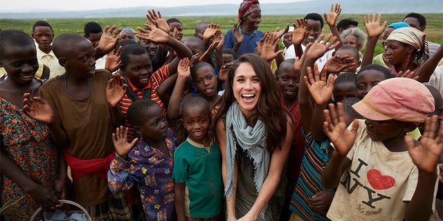Meghan and children celebrating clean water, in January 2016, at Kabeza Borehole, Rwanda. This borehole was built by World Vision in 2013 and benefits 1,000 people.