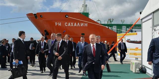 Russian President Vladimir Putin, foregound, walks in the Far Eastern port of Bolshoi Kamen, Russia, on Sept. 1, 2016.