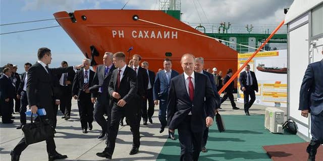 Russian President Vladimir Putin, foregound, walks in the Far Eastern port of Bolshoi Kamen, Russia, on Sept. 1, 2016.