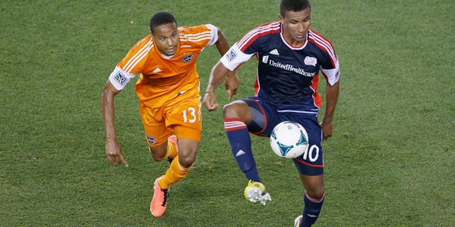 HOUSTON, TX - MAY 18: Juan Agudelo #10 of the New England Revolution plays a ball in the second half against Ricardo Clark #13 of the Houston Dynamo at BBVA Compass Stadium on May 18, 2013 in Houston, Texas. (Photo by Scott Halleran/Getty Images)