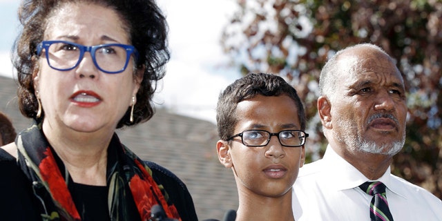 Ahmed Mohamed, 14, center, and his father Mohamed Elhassan Mohamed, right, look on as their attorney Linda Moreno, left, delivers a statement about the arrest of Ahmed during a news conference,Sept. 16, 2015, in Irving, Texas.