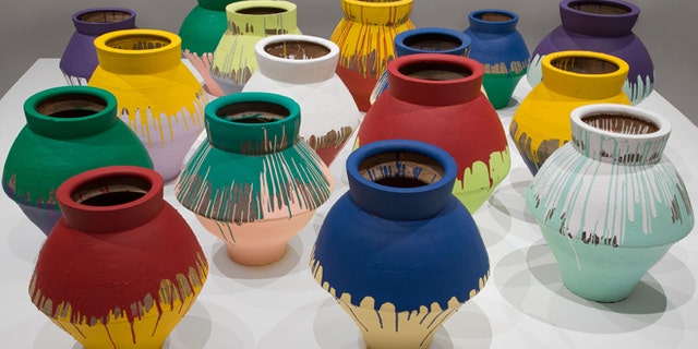 In this undated photo made available by the Brooklyn Museum of Art, shows a series of 16 vases that are part of an installation by Chinese artist Wei Wei and currently on display at the Perez Art Museum in Miami. Artist Maximo Caminero broke one of the vases on Sunday, Feb. 16, 2014.