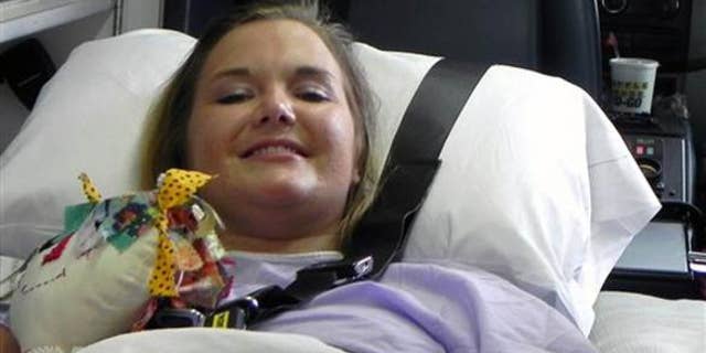 Aimee Copeland smiles as she leaves a hospital in Augusta Ga., July 2, headed for an inpatient rehabilitation clinic.