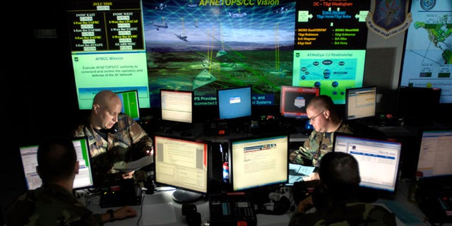 July 17, 2007: Capt. Jason Simmons and Staff Sgt. Clinton Tips update anti-virus software for Air Force units to assist in the prevention of cyberspace hackers at Barksdale Air Force Base, La.