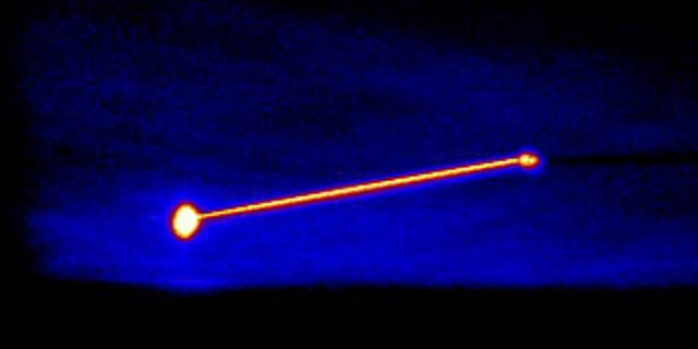 An infrared image of the Missile Defense Agency’s Airborne Laser Testbed (right) destroying a threat representative short-range ballistic missile (left).