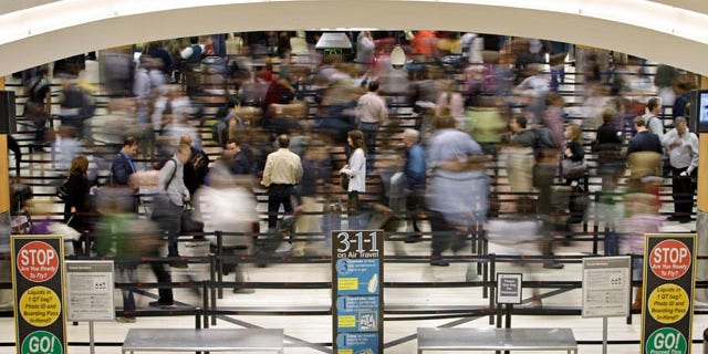Nov. 18: Passengers move through the line at a security checkpoint at Hartsfield-Jackson Atlanta International Airport in Atlanta. Experts say the TSA faces an all but impossible task: stand as the last line against unknown terror without treating everyone as a potential terrorist.
