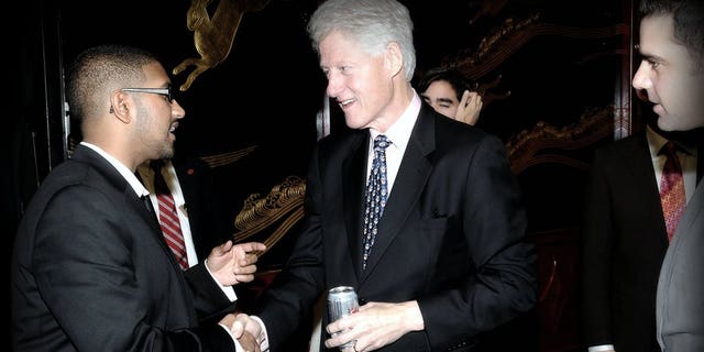 In an undated photograph, Vikrum Aiyer (left) speaks with President Bill Clinton.