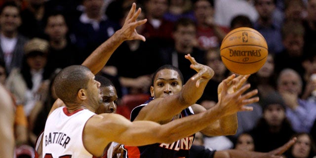 Atlanta Hawks' Al Horford (15) passes the ball as Miami Heat's Shane Battier (31) defends during the first half of an NBA basketball game, Monday, Jan. 2, 2012, in Miami. (AP Photo/Lynne Sladky)