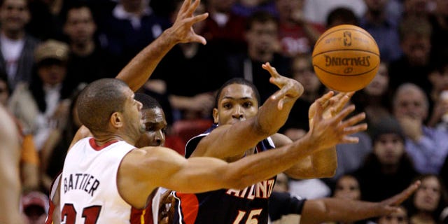 Atlanta Hawks' Al Horford (15) passes the ball as Miami Heat's Shane Battier (31) defends during the first half of an NBA basketball game, Monday, Jan. 2, 2012, in Miami. (AP Photo/Lynne Sladky)