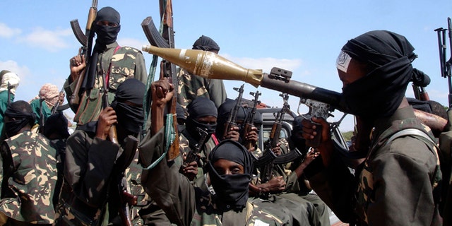 In this Dec. 8, 2008 file photo, armed al-Shabaab fighters on pickup trucks prepare to travel into the city, just outside Mogadishu, in Somalia.