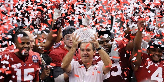 FILE - In this Jan. 9, 2012 file photo, Alabama head football coach Nick Saban celebrates with his team after the BCS National Championship college football game against LSU in New Orleans. Saban's new contract _ expected to be in the $7 million range _ is set to be formally considered by the board of trustees. The trustees will also vote on deals for 10 of his assistants, including new offensive coordinator Lane Kiffin. (AP Photo/Gerald Herbert, File)