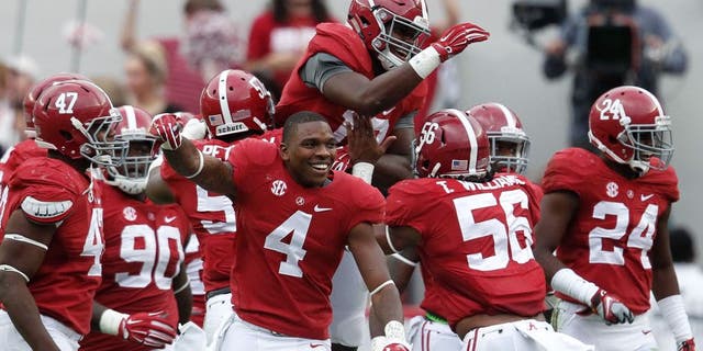 Oct 18, 2014; Tuscaloosa, AL, USA; Alabama Crimson Tide linebacker Reggie Ragland (19) is congratulated by teammates after he intercepted a pass from Texas A&M Aggies quarterback Kenny Hill (not shown) at Bryant-Denny Stadium. The Crimson Tide defeated the Aggies 59-0. Mandatory Credit: Marvin Gentry-USA TODAY Sports