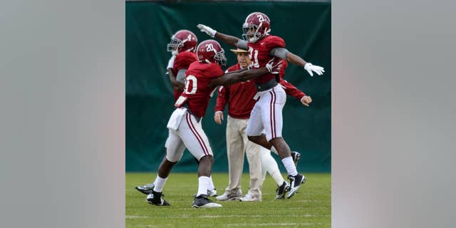 Alabama head coach Nick Saban tracks Alabama defensive backs Jarrick Williams (20) and Maurice Smith (21) as they work through drills during Alabama football practice, Tuesday, November 25, 2014, at the Thomas-Drew Practice Facility in Tuscaloosa, Ala. (AP Photo/AL.com, Vasha Hunt ) MAGS OUT (