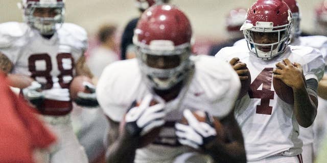 Alabama running back T.J. Yeldon (4) prepares for running drills during an NCAA college football practice at Hank Crisp indoor practice facility on Monday, Aug. 25, 2014, in Tuscaloosa, Ala. (AP Photo/Brynn Anderson)