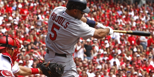 St. Louis Cardinals' Albert Pujols hits a solo home run off Cincinnati Reds pitcher Aaron Harang in the first inning of a baseball game, Monday, April 5, 2010, in Cincinnati. Cincinnati Reds' Ramon Hernandez catches at left.