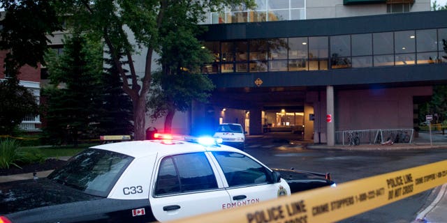 Police investigate the scene after three people were killed in an apparent attempted armed robbery at the University of Alberta in Edmonton, Canada on Friday, June 15, 2012. The robbery happened in the Hub Mall area, which is a combination of student residences and 54 shops. (AP Photo/The Canadian Press, Ian Jackson)