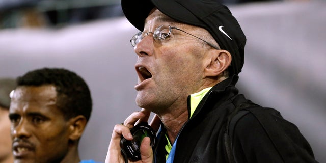 Former distance runner Alberto Salazar yells out lap times to distance runner Mo Farah, from Britain, during the 10,000-meter race in the Prefontaine Classic track and field meet in Eugene, Ore., Friday, May 29, 2015.