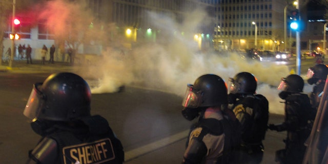 Riot police launch tear gas in downtown Albuquerque, N.M. following a 10-hour protest around the city, March 30, 2014.