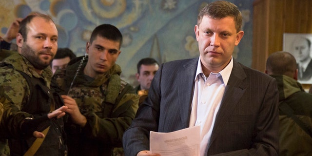 Nov. 2, 2014: Pro-Russian rebel leader Alexander Zakharchenko prepares to casts his ballot during supreme council and presidential elections in the city of Donetsk, eastern Ukraine.