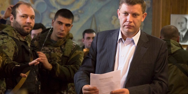 Nov. 2, 2014: Pro-Russian rebel leader Alexander Zakharchenko prepares to casts his ballot during supreme council and presidential elections in the city of Donetsk, eastern Ukraine.