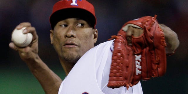 Texas Rangers relief pitcher Alexi Ogando throws during the seventh inning of Game 5 of baseball's World Series against the St. Louis Cardinals Monday, Oct. 24, 2011, in Arlington, Texas. (AP Photo/Matt Slocum)