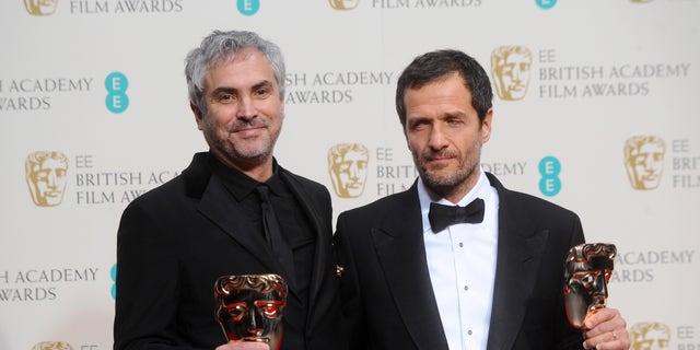 LONDON, ENGLAND - FEBRUARY 16:  Director Alfonso Cuaron and producer  David Heyman, winner of the Outstanding British Film award, pose in the winners room at the EE British Academy Film Awards 2014 at The Royal Opera House on February 16, 2014 in London, England.  (Photo by Anthony Harvey/Getty Images)