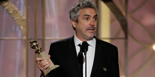 BEVERLY HILLS, CA - JANUARY 12:  In this handout photo provided by NBCUniversal, Alfonso Cuaron accepts the award for Best Director - Motion Picture for "Gravity" during the 71st Annual Golden Globe Award at The Beverly Hilton Hotel on January 12, 2014 in Beverly Hills, California.  (Photo by Paul Drinkwater/NBCUniversal via Getty Images)