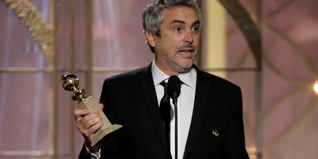 BEVERLY HILLS, CA - JANUARY 12: In this handout photo provided by NBCUniversal, Alfonso Cuaron accepts the award for Best Director - Motion Picture for "Gravity" during the 71st Annual Golden Globe Award at The Beverly Hilton Hotel on January 12, 2014 in Beverly Hills, California. (Photo by Paul Drinkwater/NBCUniversal via Getty Images)