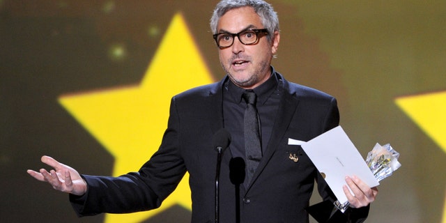 SANTA MONICA, CA - JANUARY 16: Director Alfonso Cuarón accepts the Best Director award for "Gravity" onstage during the 19th Annual Critics' Choice Movie Awards at Barker Hangar on January 16, 2014 in Santa Monica, California. (Photo by Kevin Winter/Getty Images)