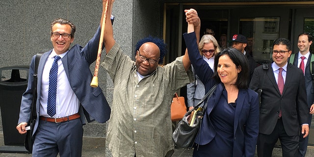 Alfred Swinton and his lawyers walk out of Superior Court in Hartford, Conn., Thursday, June 8, 2017, after a judge dismissed his murder conviction in a 1991 killing. Swinton was released and will be under house arrest while the murder charge remains pending. New DNA testing showed he wasn't the source of bite marks on the victim's body. (AP Photo/Dave Collins)