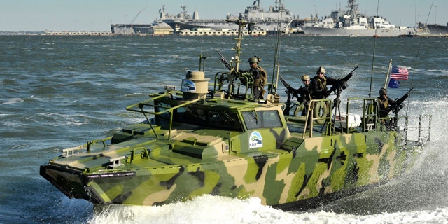 Sailors assigned to Riverine Group 1 conduct maneuvers aboard Riverine Command Boat (Experimental) (RCB-X) at Naval Station Norfolk, Va. on Oct. 22, 2010. The RCB-X is powered by an alternative fuel blend that's 50 percent algal and 50 percent NATO F-76 fuel, reducing the total energy consumption on naval ships.