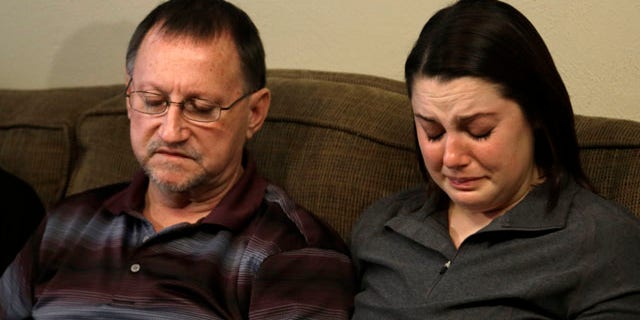 Jan. 22, 2013: Mike Lovelady, left, sits with his niece Erin Lovelady as she cries and talks about her father Victor Lovelady.