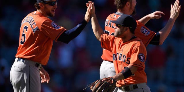 ANAHEIM, CA - SEPTEMBER 13: Jake Marisnick #6 and Jose Altuve #27 of the Houston Astros high-five while celebrating after defeating the Los Angeles Angels of Anaheim 5-3 at Angel Stadium of Anaheim on September 13, 2015 in Anaheim, California. (Photo by Matt Brown/Angels Baseball LP/Getty Images)