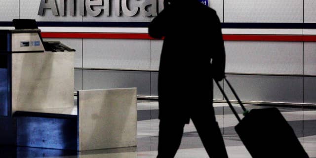 American and US Airways announced changes to their policies on checked-bag fees and redeeming miles for free flights.