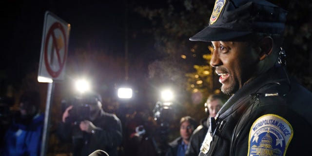 December 11, 2013: Washington Metro Police Lt. Jesse Porter speaks to the media outside American University in Washington. At the news conference after the lockdown had been lifted, Porter said the lockdown order was given after a student reported seeing a man with a holster on the shuttle. Porter said police have not confirmed that there was a weapon inside the holster. Police identified the man and determined that he was an off-duty police officer. (AP Photo/Alex Brandon)