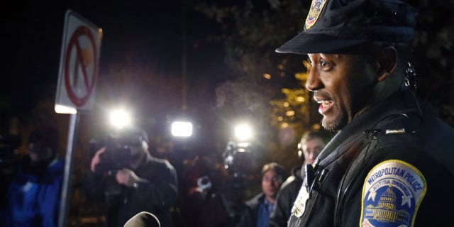 December 11, 2013: Washington Metro Police Lt. Jesse Porter speaks to the media outside American University in Washington. At the news conference after the lockdown had been lifted, Porter said the lockdown order was given after a student reported seeing a man with a holster on the shuttle. Porter said police have not confirmed that there was a weapon inside the holster. Police identified the man and determined that he was an off-duty police officer. (AP Photo/Alex Brandon)