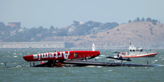 May 9, 2013: The overturned Artemis Racing AC72 catamaran, an America's Cup entry from Sweden, is towed past Treasure Island after the boat capsized during training in San Francisco Bay in San Francisco, Calif.