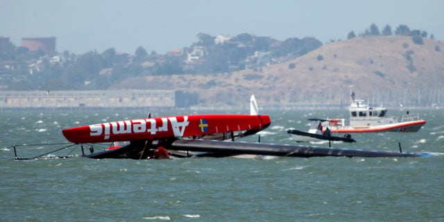 May 9, 2013: The overturned Artemis Racing AC72 catamaran, an America's Cup entry from Sweden, is towed past Treasure Island after the boat capsized during training in San Francisco Bay in San Francisco, Calif.