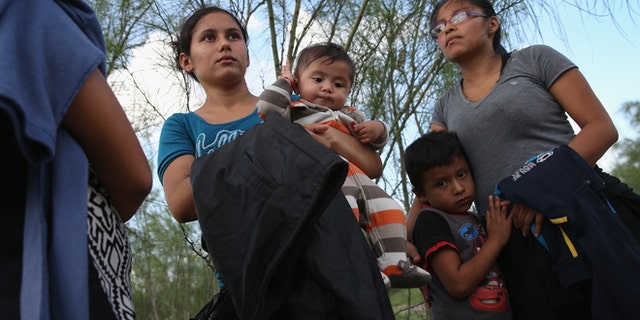 MCALLEN, TX - SEPTEMBER 08: Families of Central American immigrants turn themselves in to U.S. Border Patrol agents after crossing the Rio Grande River from Mexico on September 8, 2014 to McAllen, Texas. Although the numbers of such immigrant families and unaccompanied minors have decreased from a springtime high, thousands continue to cross in the border illegally into the United States. The Rio Grande Valley sector is the busiest area for illegal border crossings, especially for Central Americans, into the U.S. (Photo by John Moore/Getty Images)