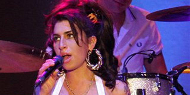 Jan. 8, 2011: In this file photo, British artist Amy Winehouse performs during her show in Florianopolis, Brazil.
