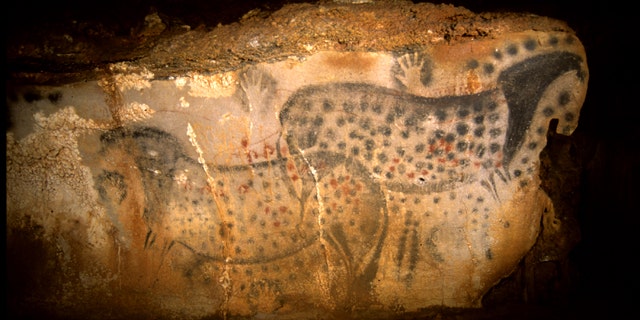 This undated photo provided by the Pech Merle Prehistory Center shows a cave painting of pair of spotted horses, found in the Pech Merle Cave in Cabrerets, southern France. Scientists estimate the drawing, measuring about 4 meters wide by 1.5 meters high, is about 25,000 years old.