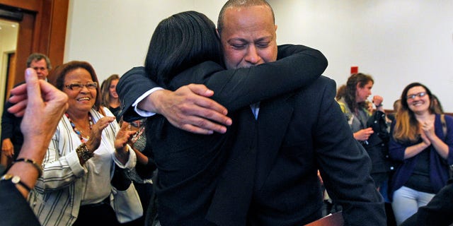 Angel Echavarria hugs his daughter after he is released in Salem Superior Court on May 18, 2015.