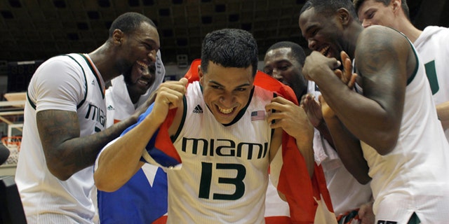 Angel Rodriguez is congratulated by his teammates in San Juan, Sunday, Nov. 22, 2015.