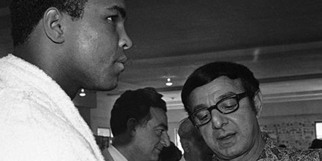 FILE - In this March 4, 1971, file photo, heavyweight challenger Muhammad Ali, left, has fists taped by trainer Angelo Dundee in Miami Beach as Ali resumes his training for an upcoming title bout with champion Joe Frazier in Madison Square Garden.