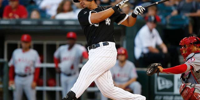 Chicago White Sox's Jose Abreu hits a single against the Los Angeles Angels during the first inning of the second baseball game of a double header on Tuesday, July 1, 2014, in Chicago. (AP Photo/Andrew A. Nelles)